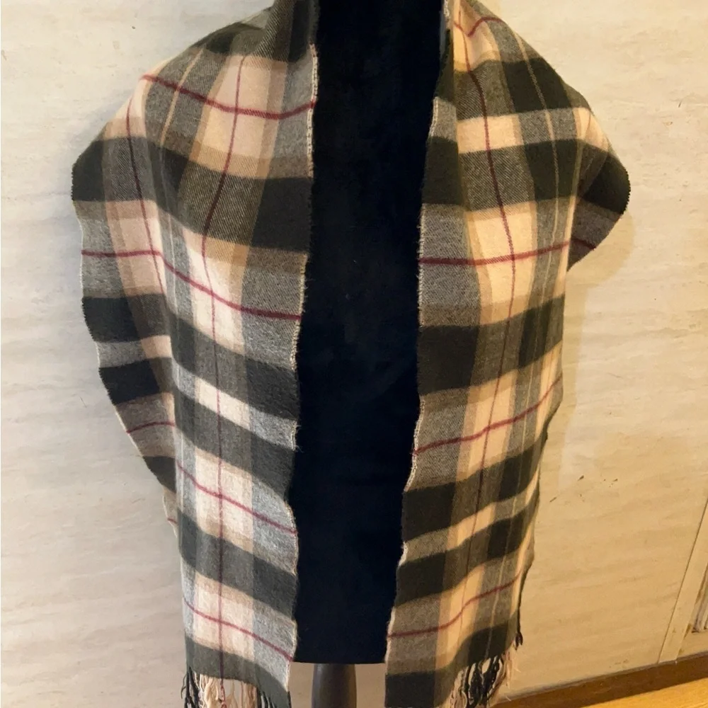 Scarf in a brown,pink, and tan plaid pattern with fringe 100% Cashmere